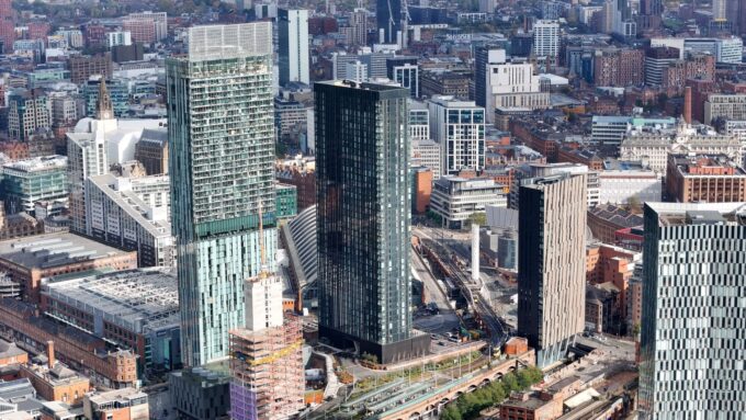 Aerial view of Manchester city centre with modern towers and historic buildings