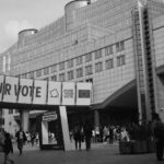 European Parliament building with a voting message